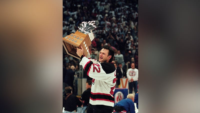 FILE -- New Jersey Devils right wing Claude Lemieux holds the Conn Smythe trophy after his...