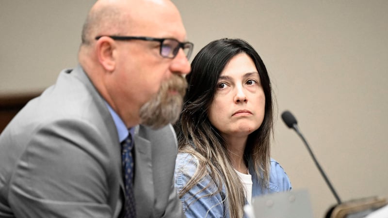 Rebecca Haro sits in court with her defense attorney Jeff Moore inside the Riverside Hall of...