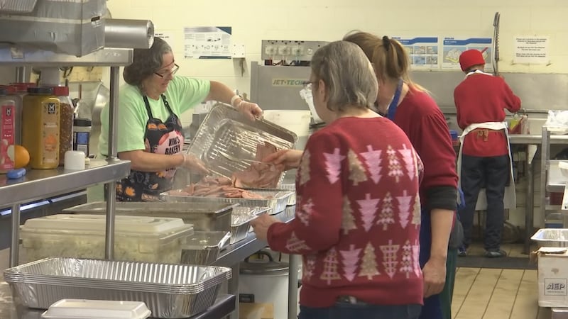 Hundreds of families lined up, and volunteers plated meals as Christmas dinner was served at...
