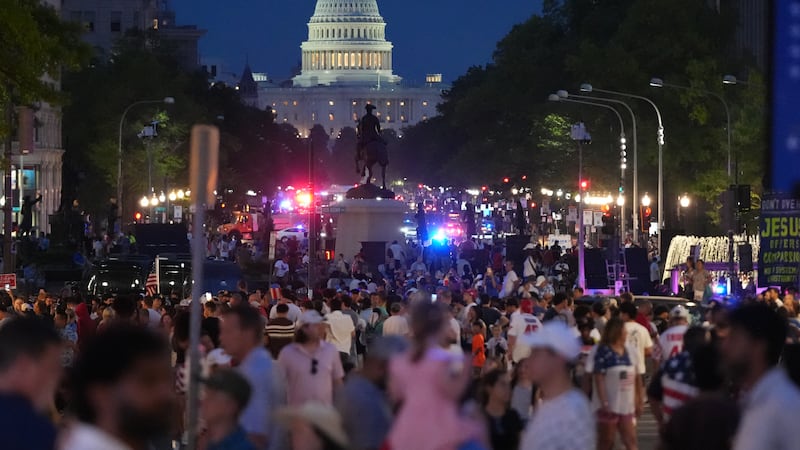 People crowd Pennsylvania Avenue after they were evacuated from the National Mall ahead of...