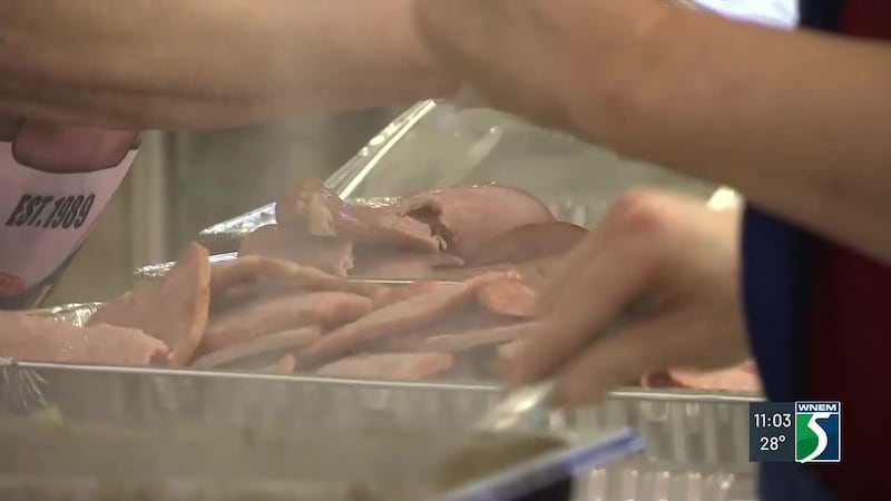 Hundreds of families lined up, and volunteers plated meals as Christmas dinner was served at...